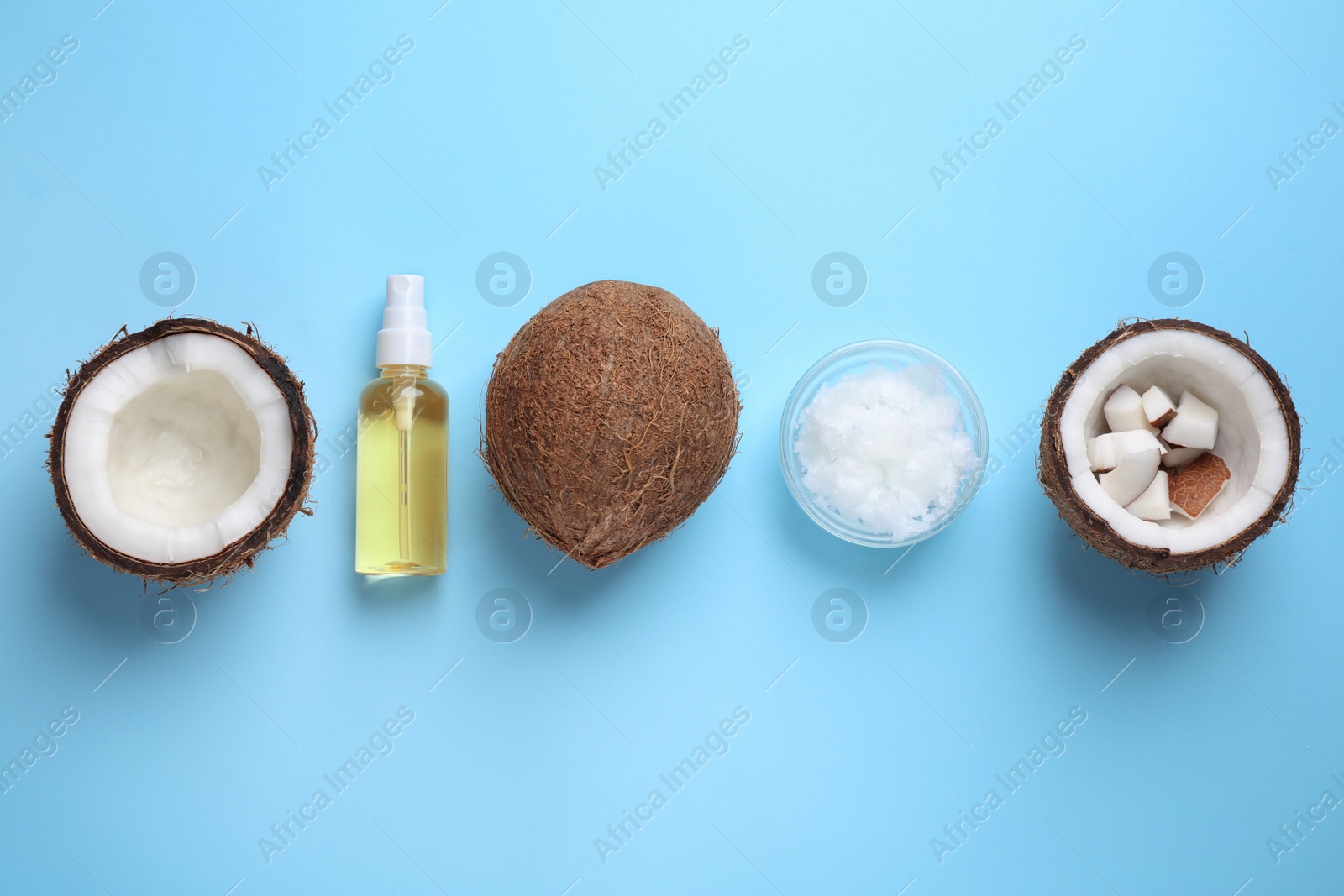 Photo of Flat lay composition with coconut oil on light blue background