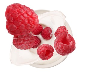 Image of Delicious ripe raspberries falling into bowl with yogurt on white background, top view