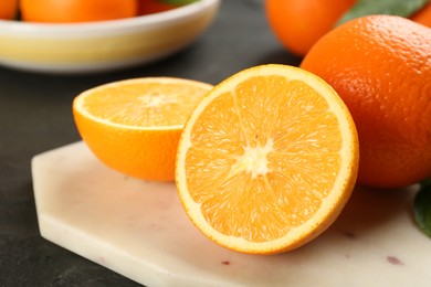 Photo of Delicious ripe oranges on white board, closeup