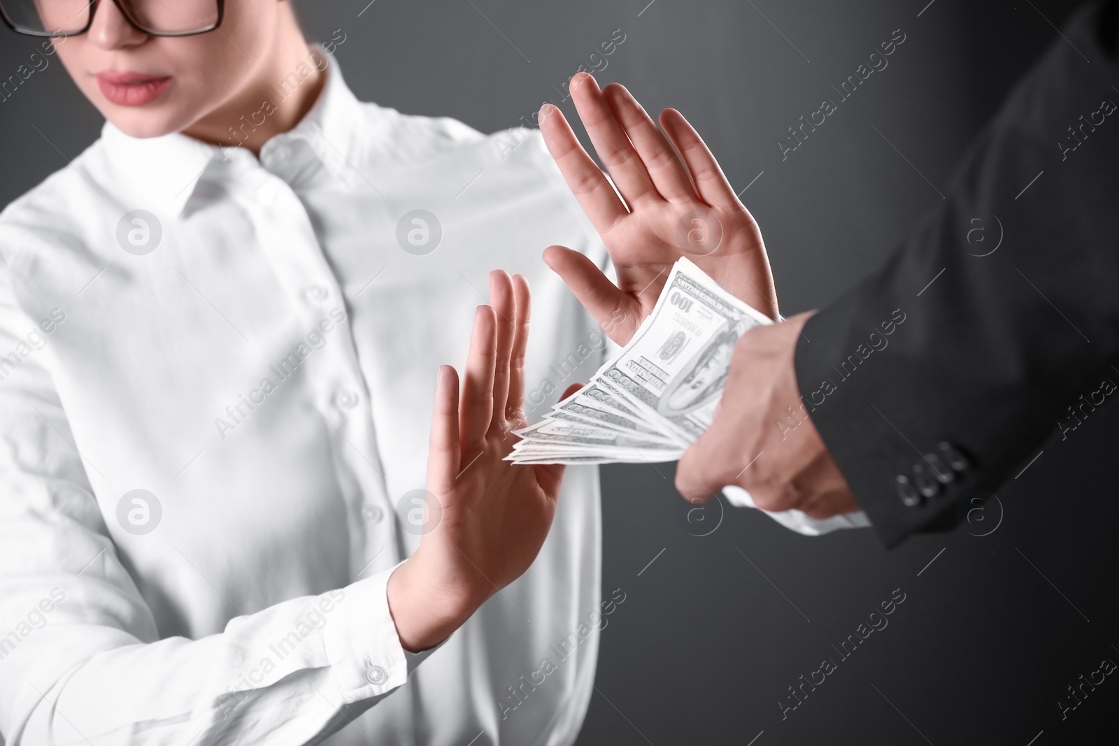 Photo of Woman refuses to take bribe money on dark background, closeup