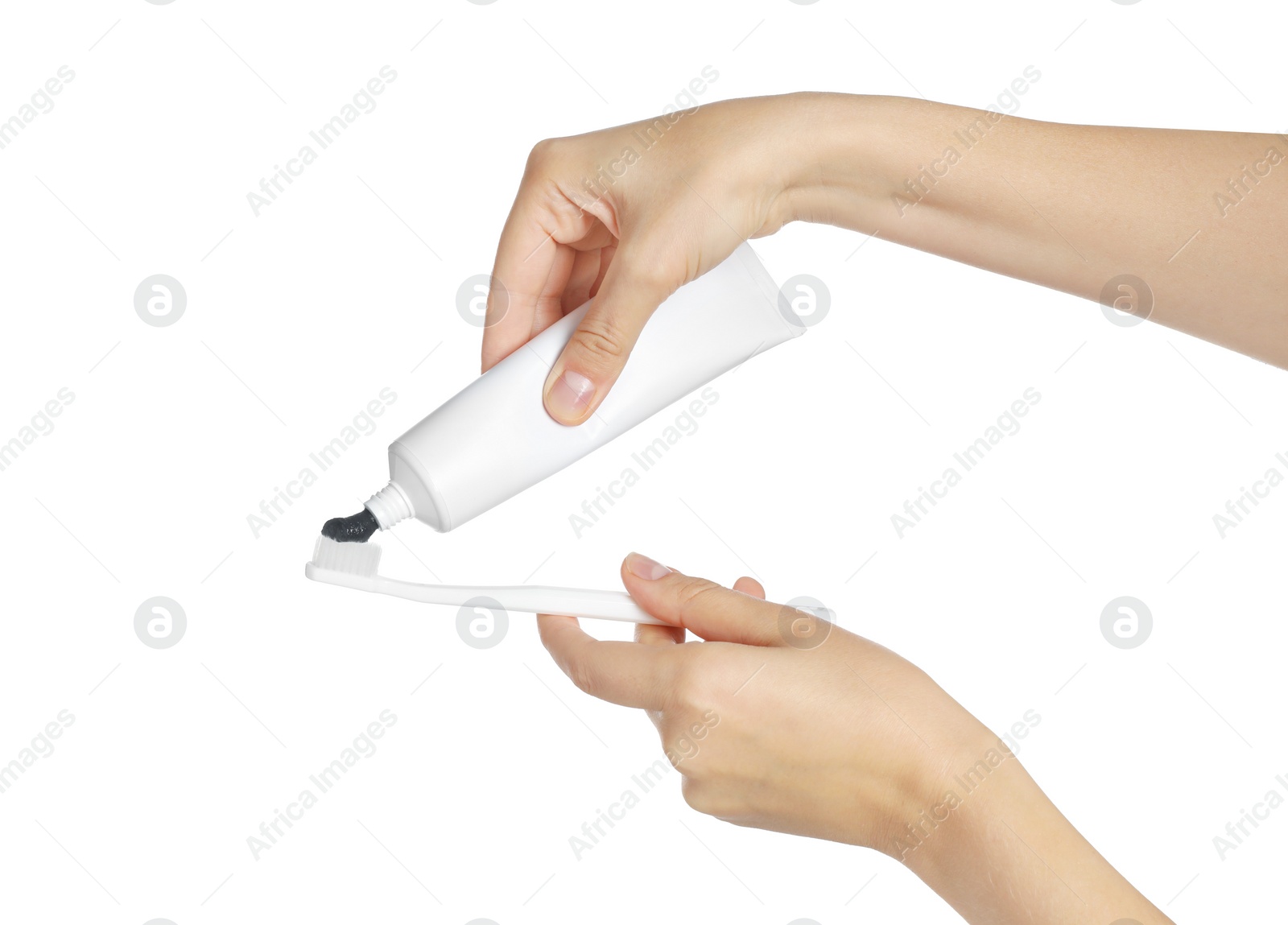 Photo of Woman applying charcoal toothpaste on brush against white background, closeup