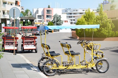 Four-wheeled bicycle outdoors on sunny day, space for text
