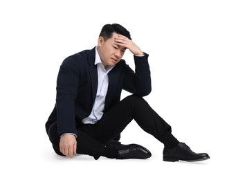 Photo of Tired businessman in suit sitting on white background