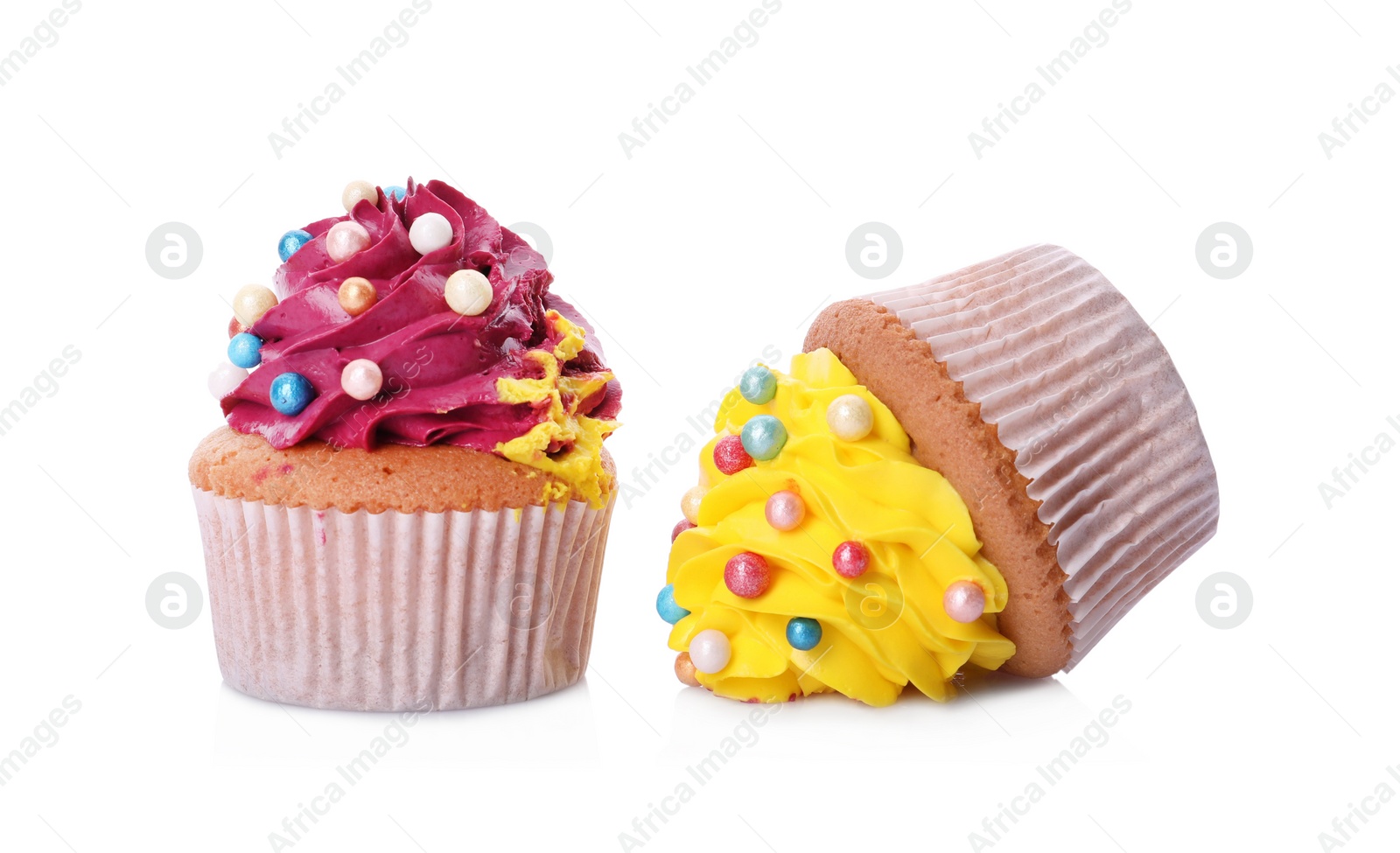 Photo of Dropped and good cupcakes on white background. Troubles happen