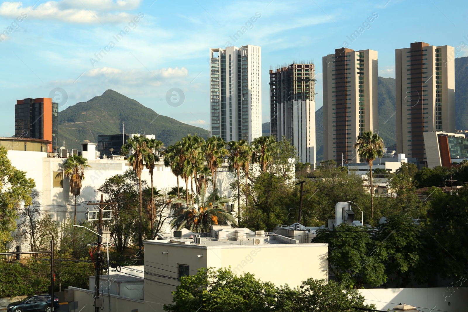 Photo of Picturesque view of mountains and city with skyscrapers