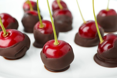 Photo of Chocolate dipped cherries on white background, closeup