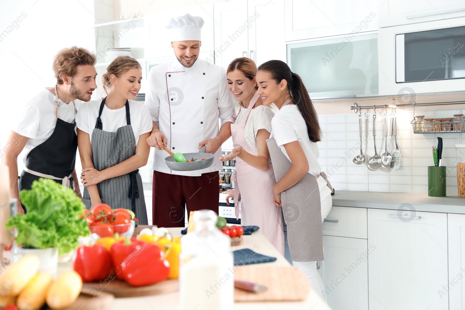 Photo of Group of people and male chef at cooking classes