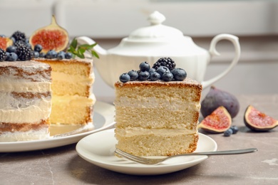 Piece of delicious homemade cake with fresh berries served on table