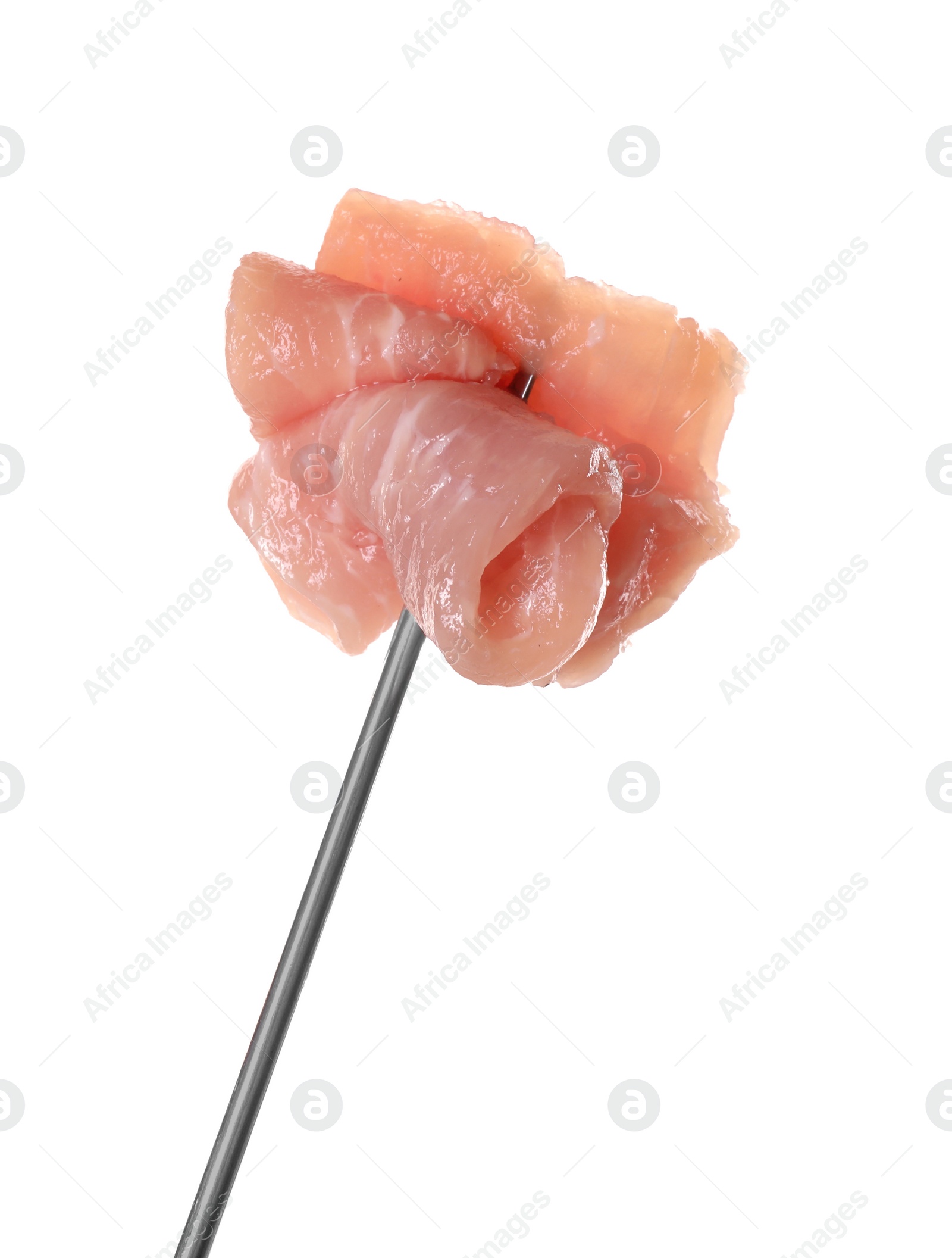 Photo of Fondue fork with pieces of raw meat isolated on white