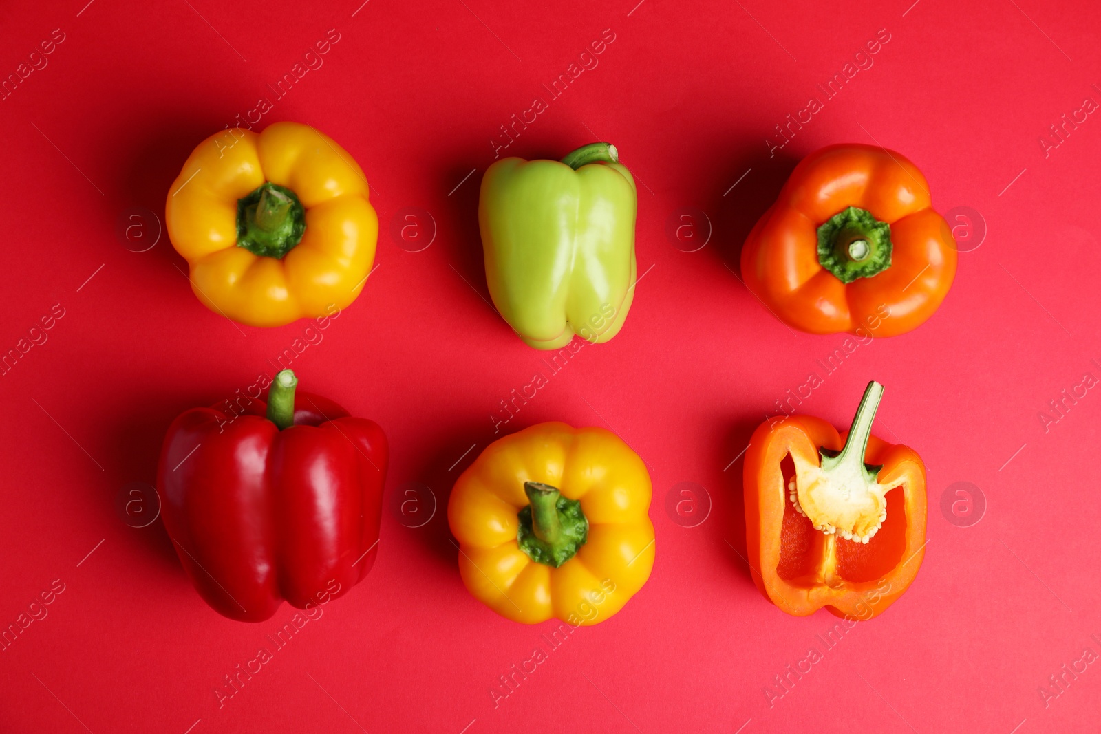 Photo of Flat lay composition with ripe bell peppers on red background