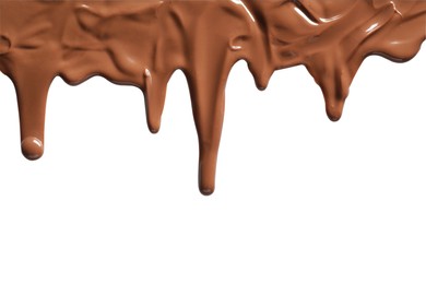 Tasty melted milk chocolate pouring down on white background