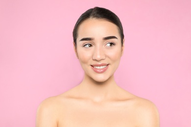 Photo of Portrait of young woman with beautiful face against color background