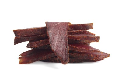 Pieces of delicious beef jerky on white background