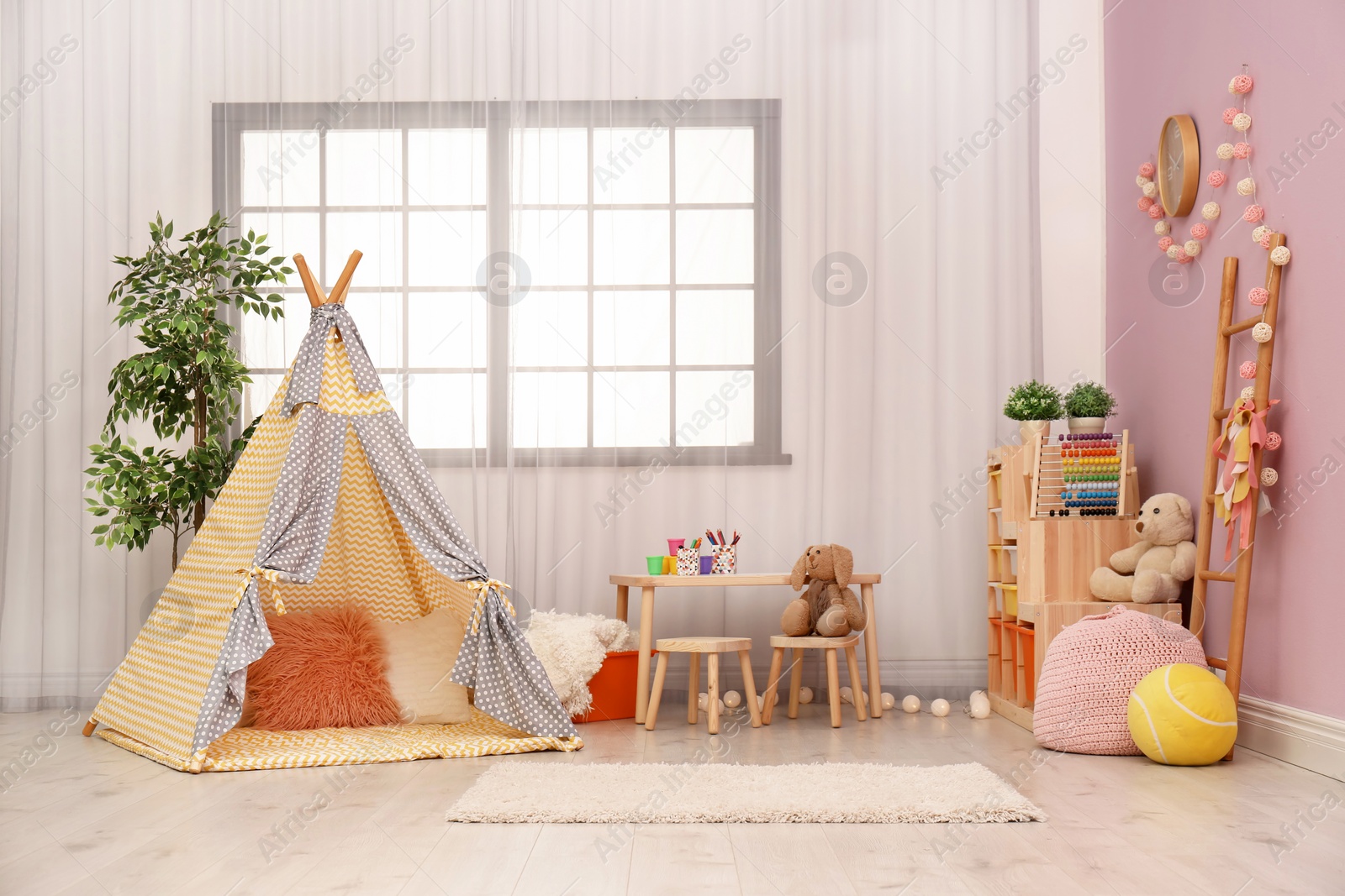 Photo of Modern nursery room interior with play tent for kids