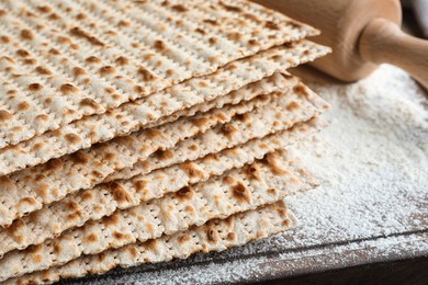 Photo of Stack of matzos on wooden board, closeup