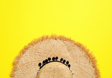 Photo of Stylish straw hat on color background, top view with space for text. Beach accessories