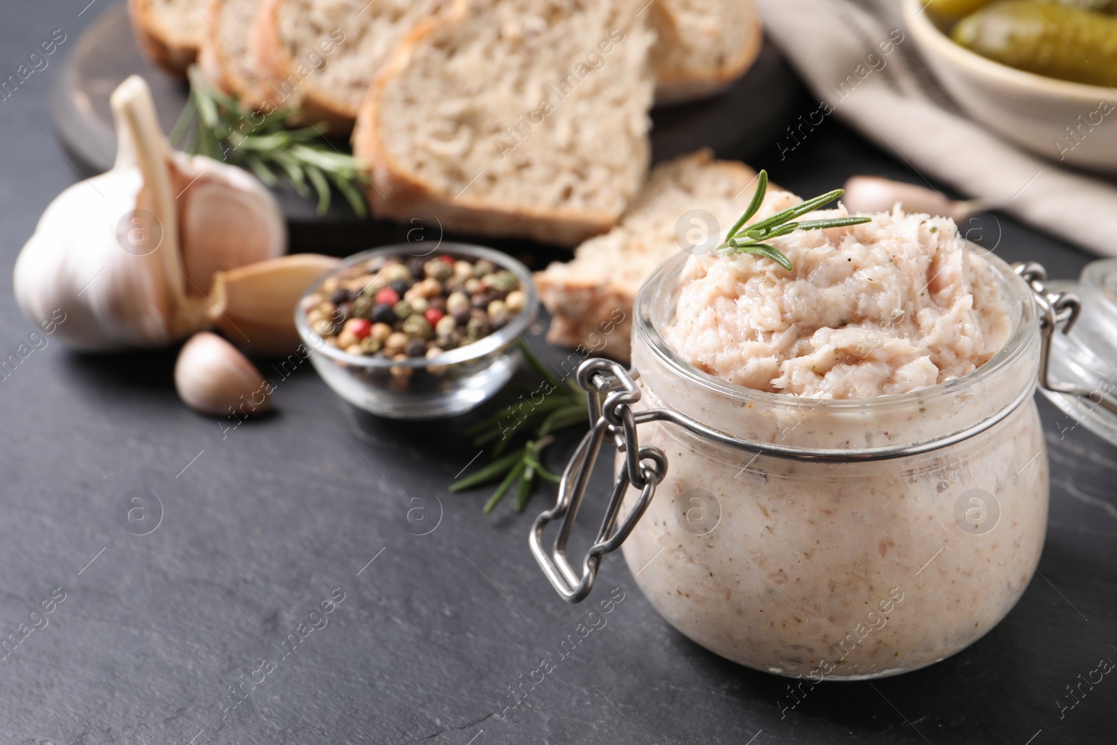 Photo of Delicious lard spread in jar on black table