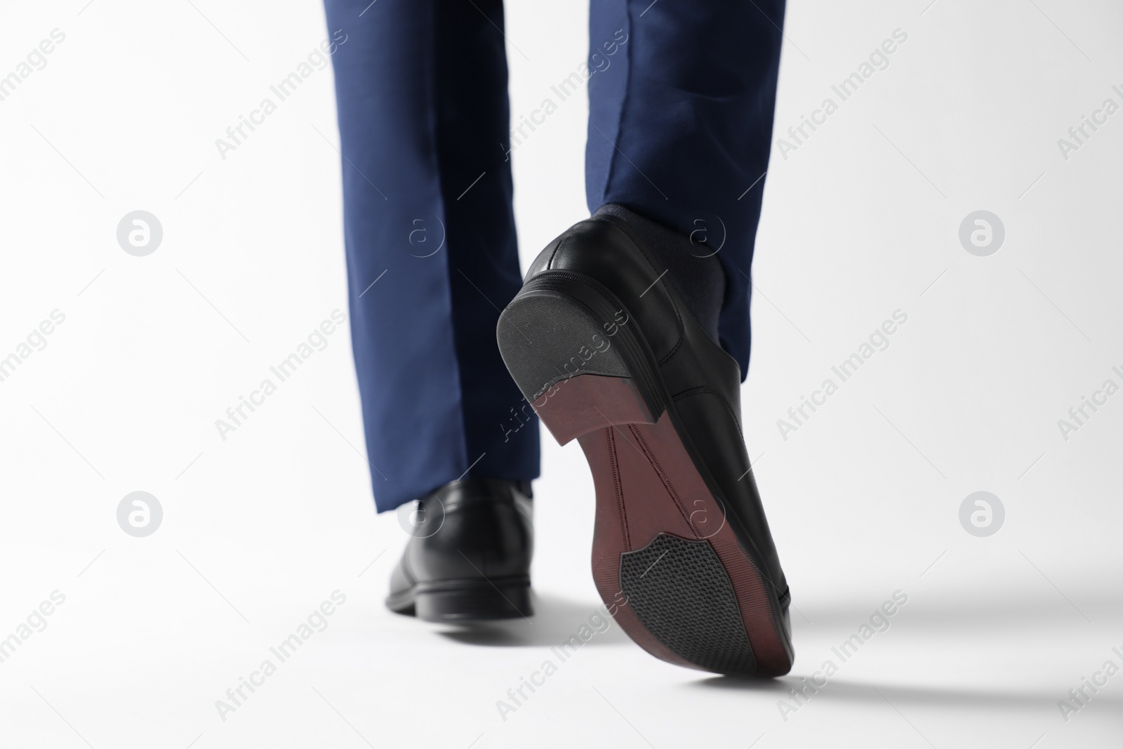 Photo of Businessman in leather shoes on white background, closeup