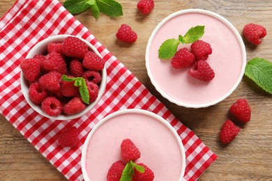 Delicious raspberry mousse with mint on wooden table, flat lay