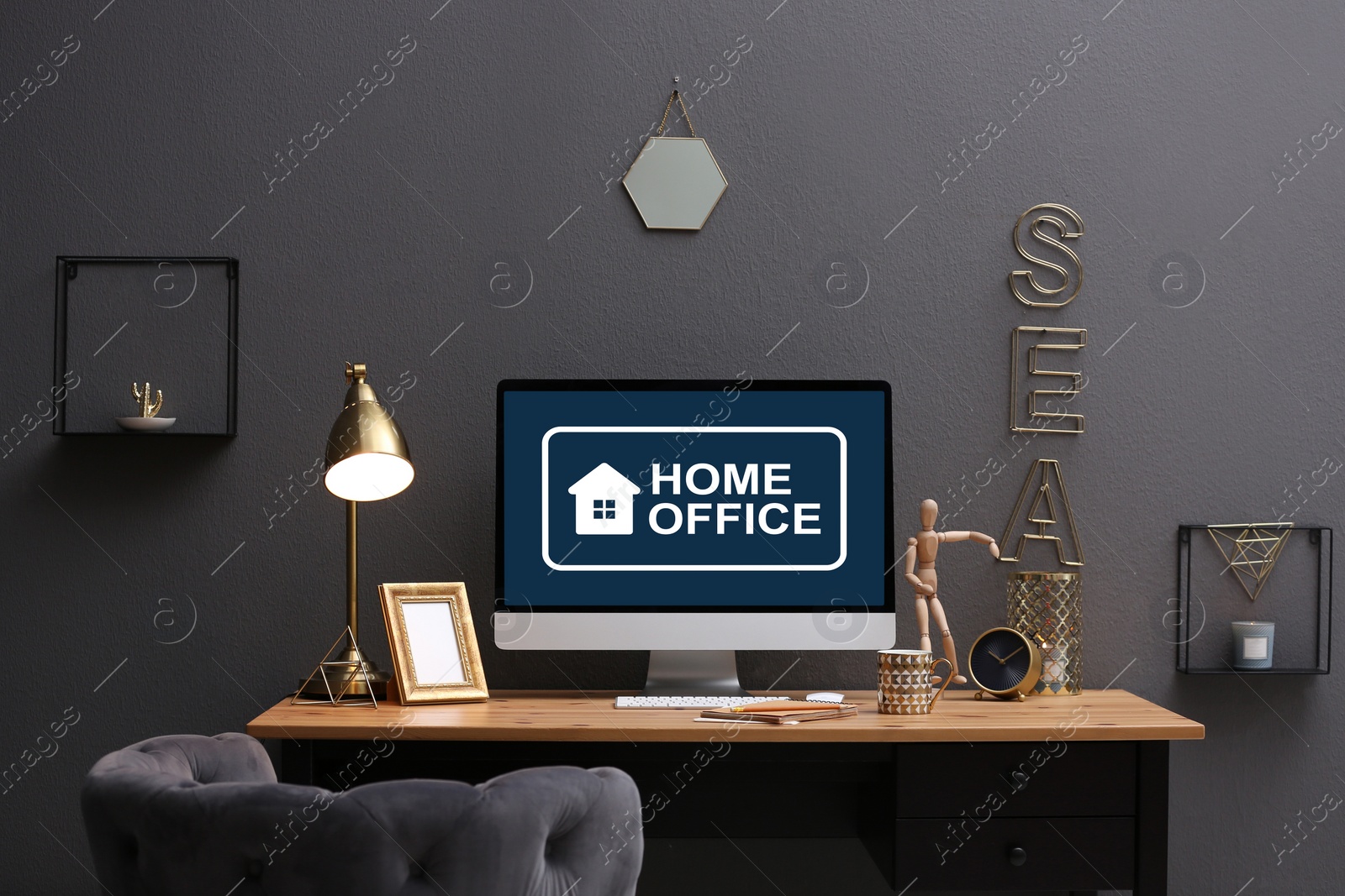 Image of Modern computer with text HOME OFFICE on table indoors