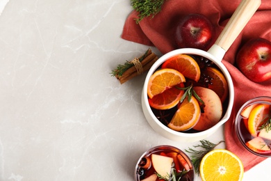 Tasty mulled wine with spices on light grey table, flat lay. Space for text