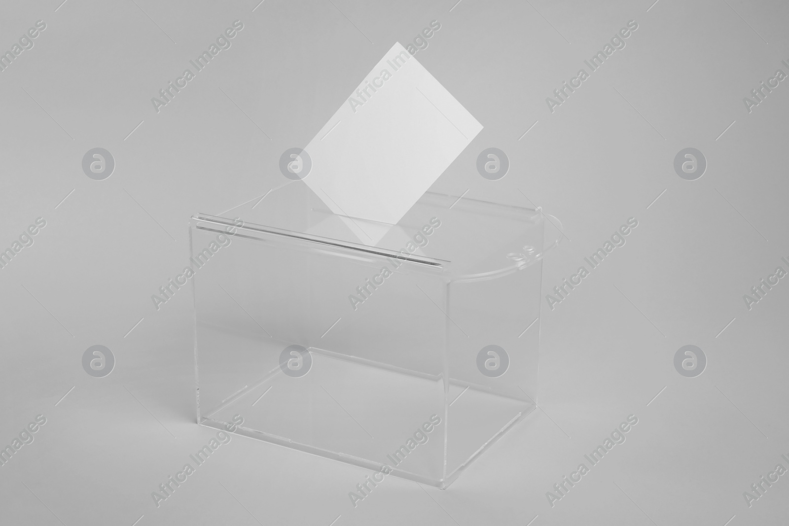 Photo of Ballot box with vote on light grey background. Election time