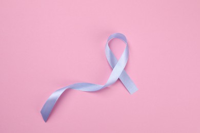 Photo of International Psoriasis Day. Ribbon as symbol of support on pink background, top view
