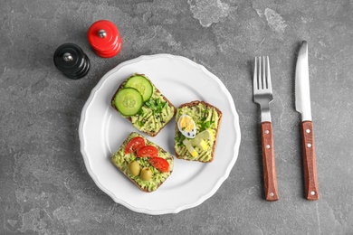 Tasty breakfast with crisp avocado  toasts on table, top view