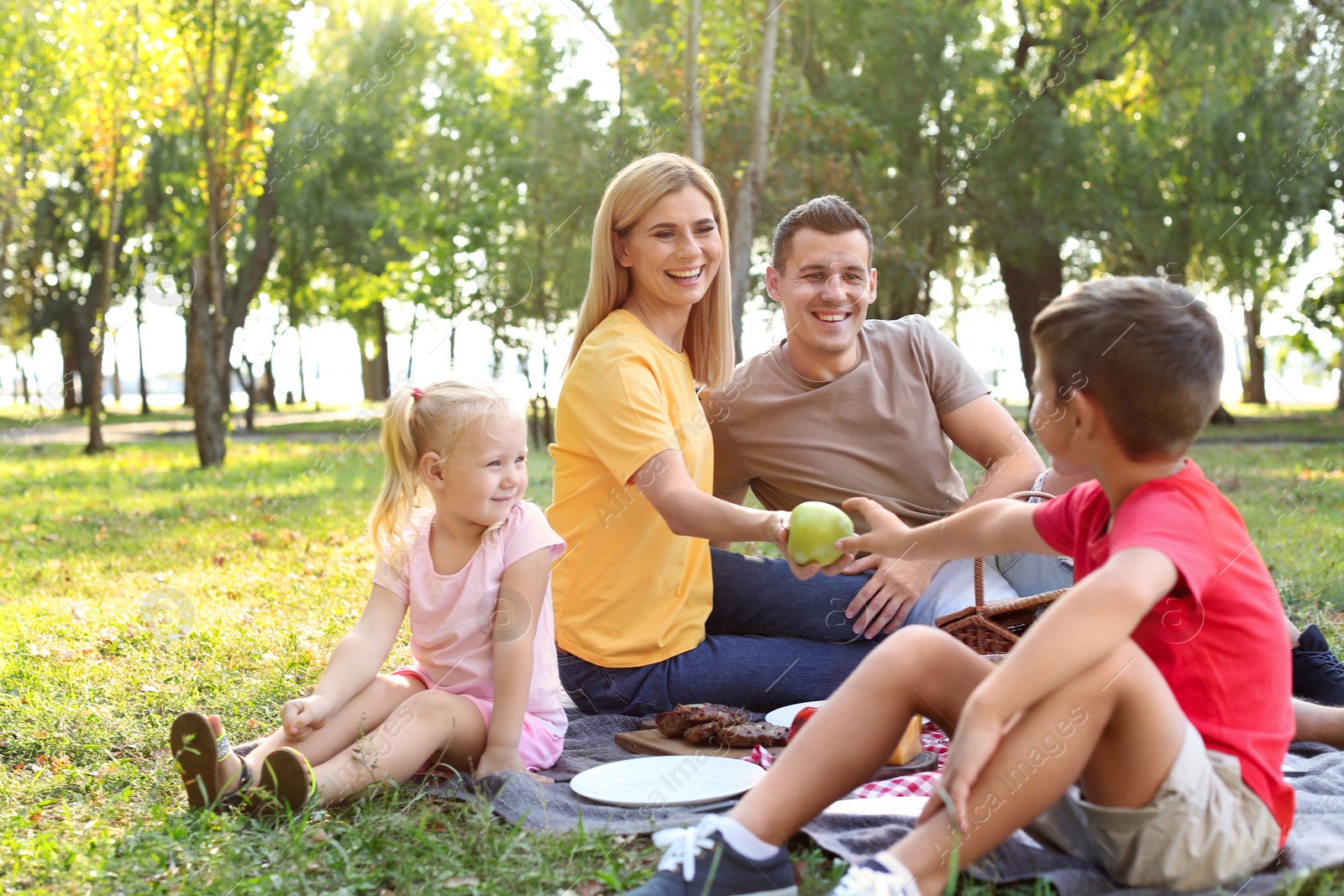 Photo of Happy family having picnic in park on sunny day