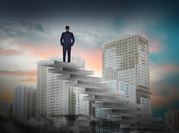 Image of Man standing on top of stairs and looking at cityscape. Way to success