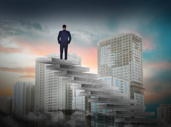 Man standing on top of stairs and looking at cityscape. Way to success