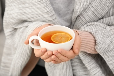 Photo of Woman with cup of hot tea for cough, closeup
