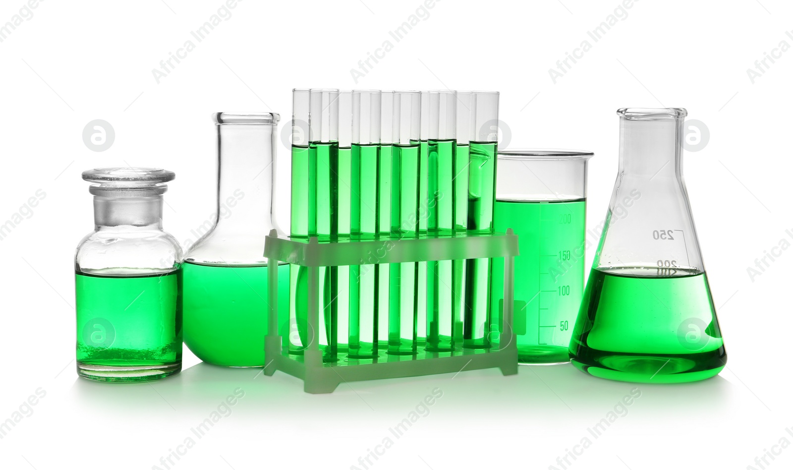 Photo of Laboratory glassware with green liquid on white background