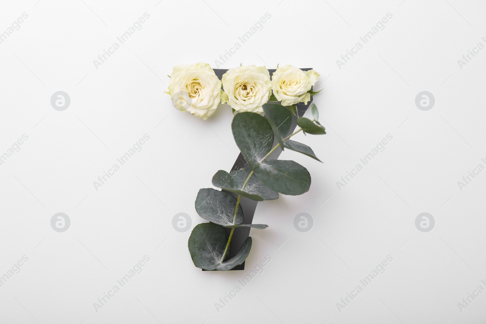 Photo of Number 7 made of beautiful flowers and eucalyptus leaves on white background, top view