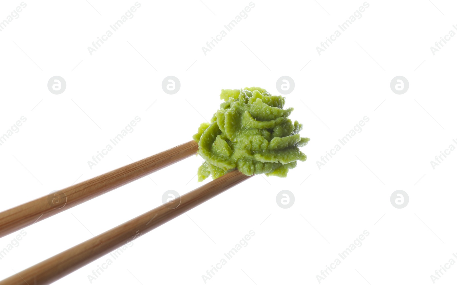 Photo of Chopsticks with swirl of wasabi paste isolated on white