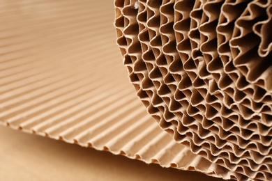 Closeup view of roll of brown corrugated cardboard, space for text. Recyclable material