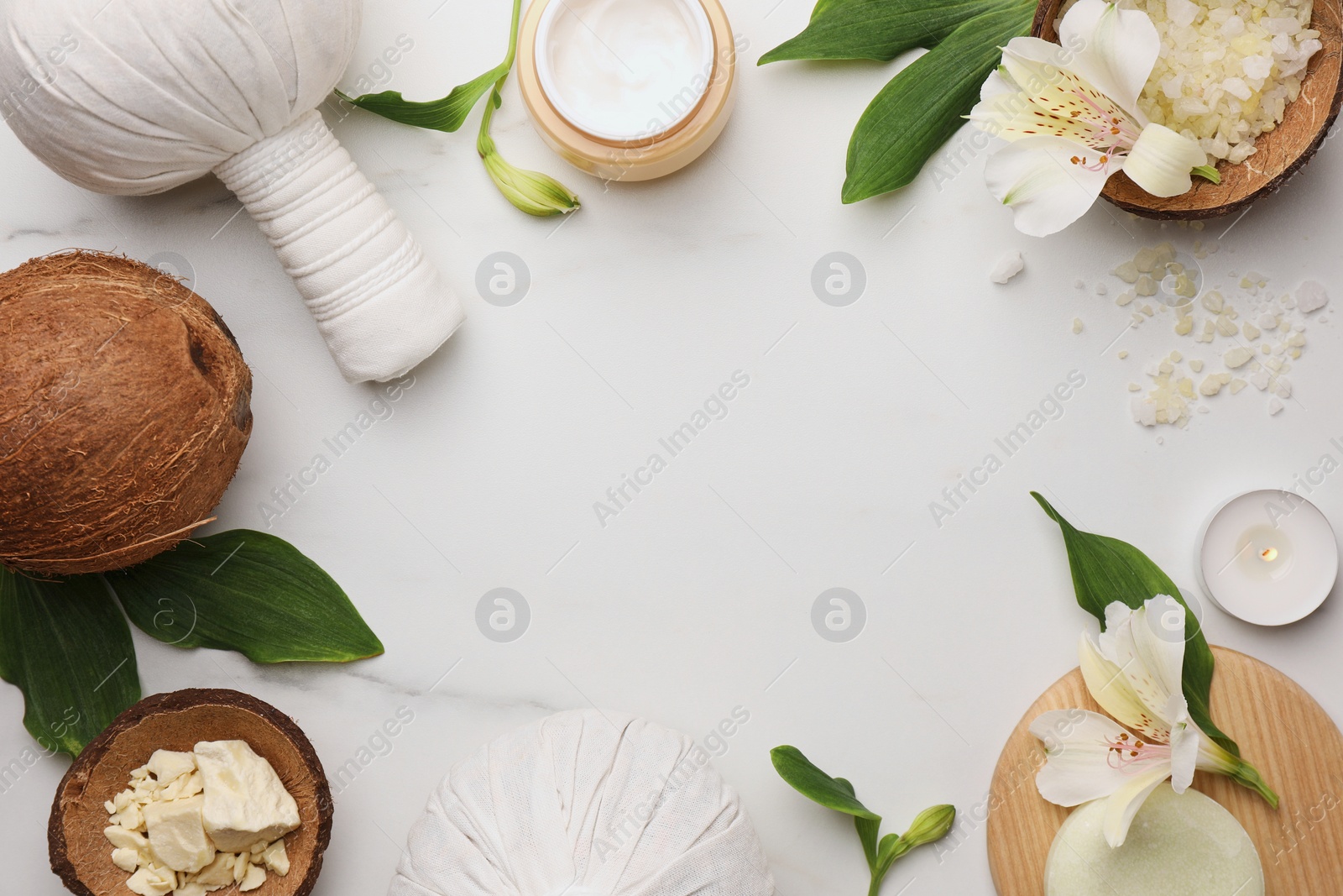 Photo of Frame made of different cosmetic products on white marble table, flat lay and space for text. Spa composition