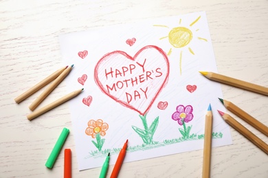 Photo of Flat lay composition with handmade greeting card for Mother's Day on light wooden table