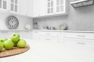 Photo of Fresh ripe apples on white wooden table in kitchen