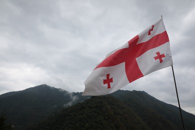 Photo of Adjara, Georgia – September 4, 2002: Georgian flag on Gvara Fortress in mountains