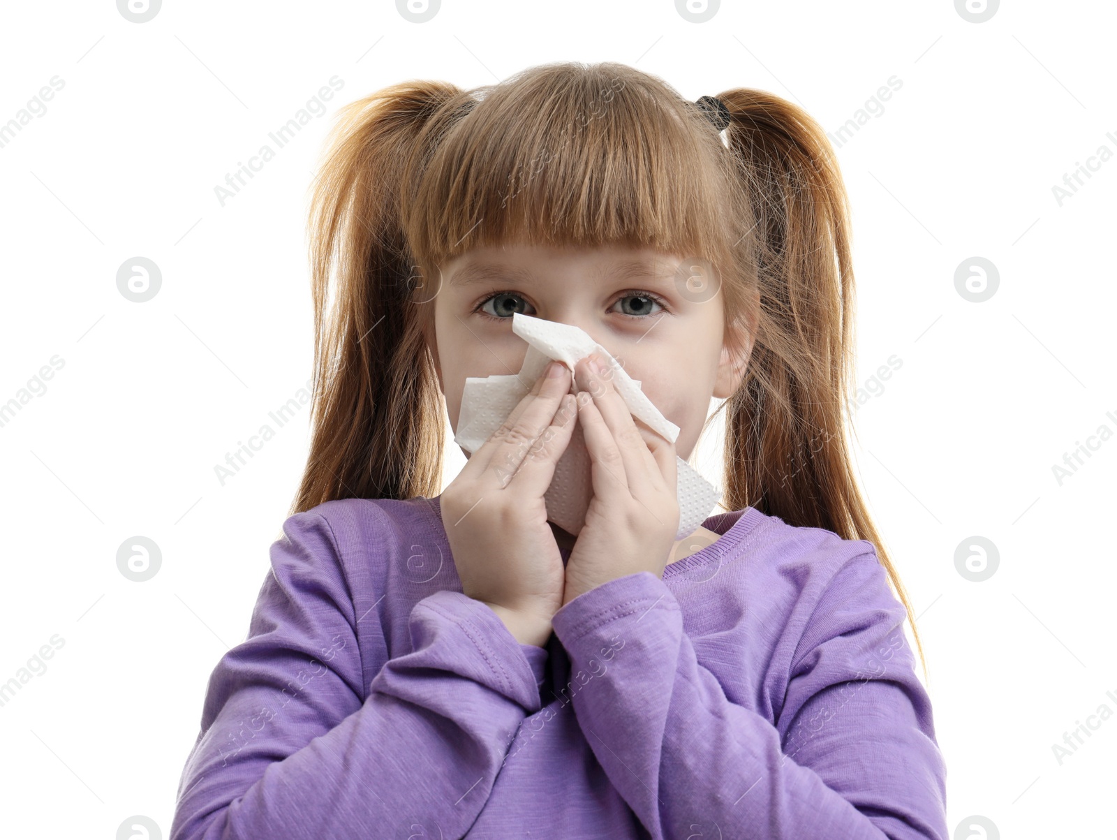 Photo of Cute little girl blowing nose against white background