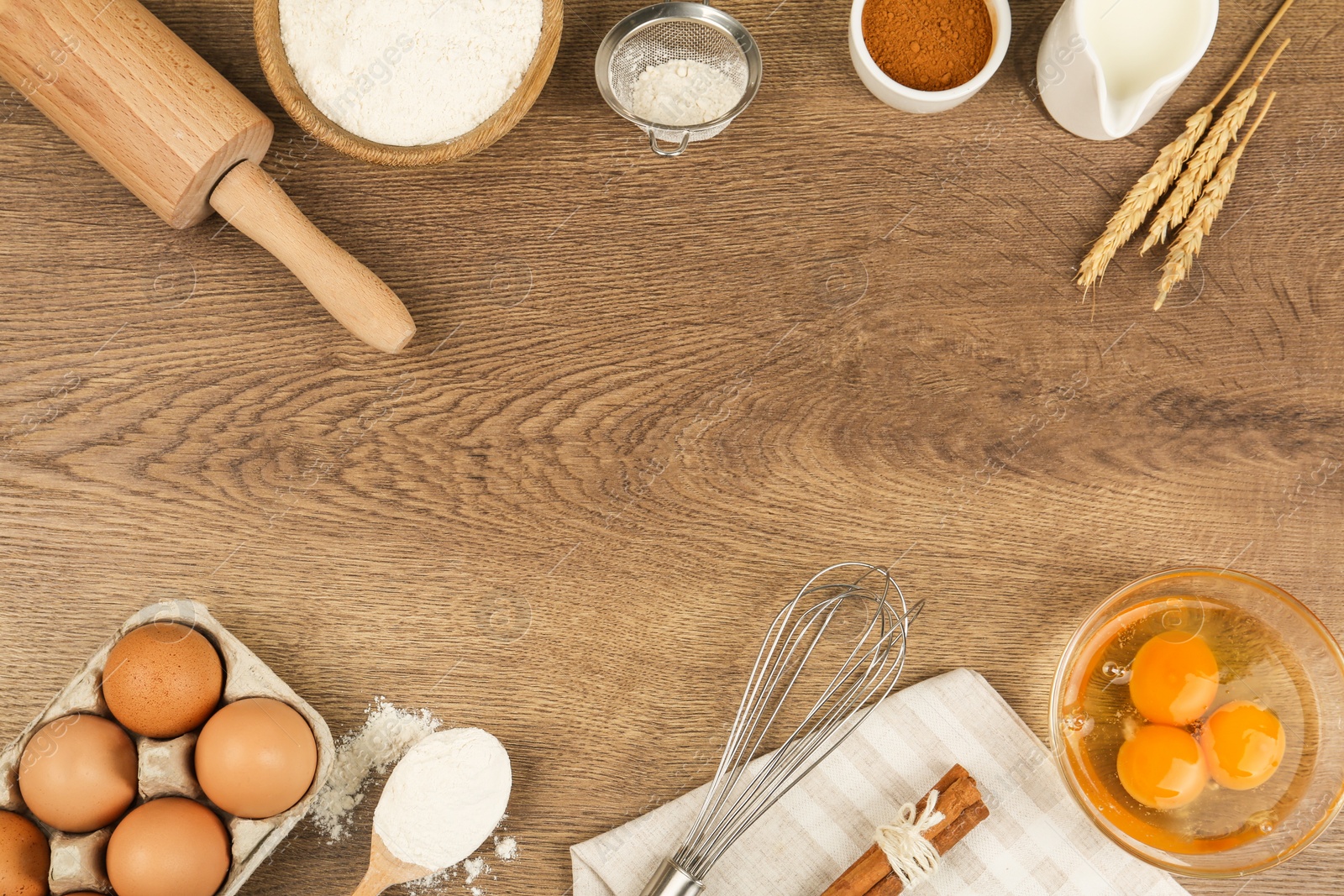 Photo of Flat lay composition with raw eggs and other ingredients on wooden background, space for text. Baking pie