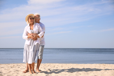 Photo of Mature couple spending time together on sea beach