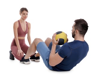 Photo of Athletic couple doing exercise with medicine ball on white background