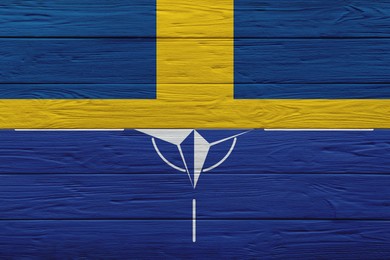 Image of Flags of Sweden and NATO on wooden background