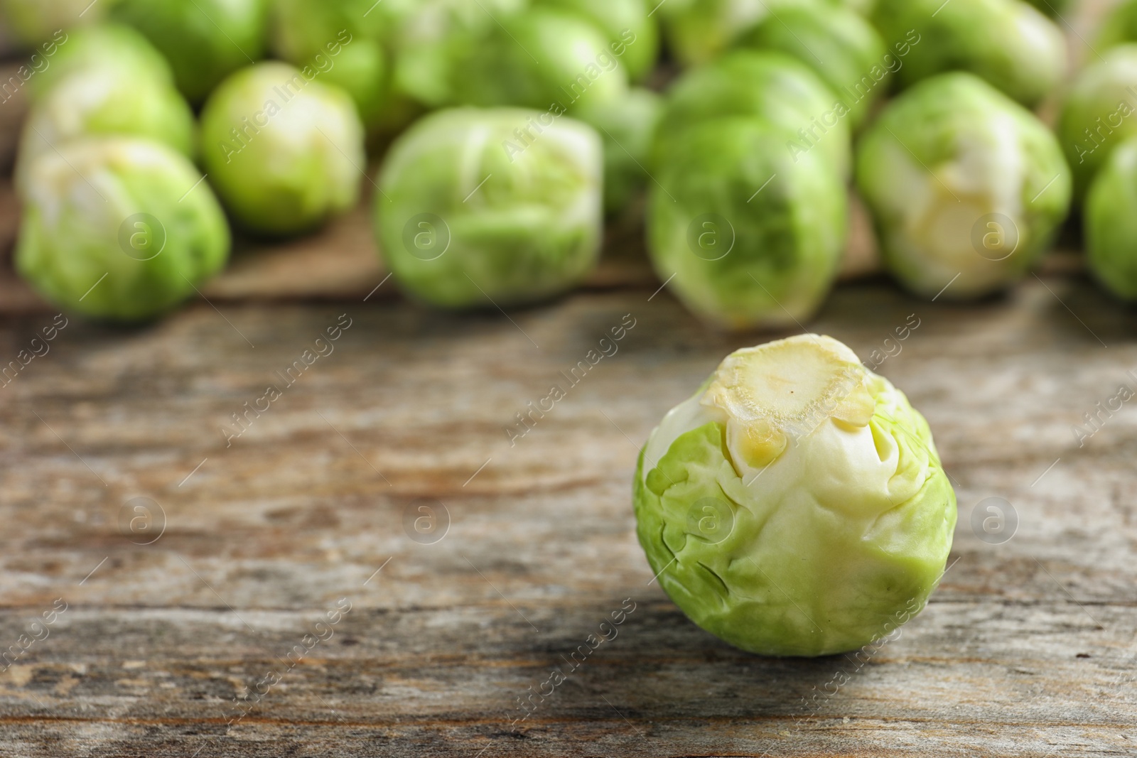 Photo of Fresh Brussels sprout on table. Space for text