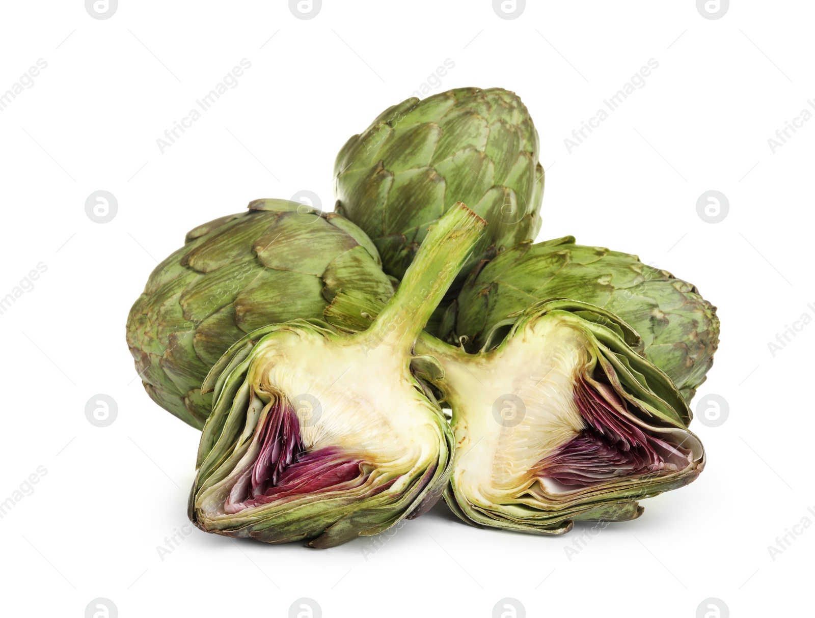 Photo of Cut and whole fresh artichokes on white background