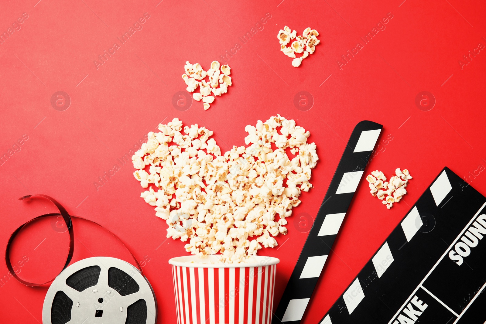 Photo of Flat lay composition with popcorn on color background. Cinema snack