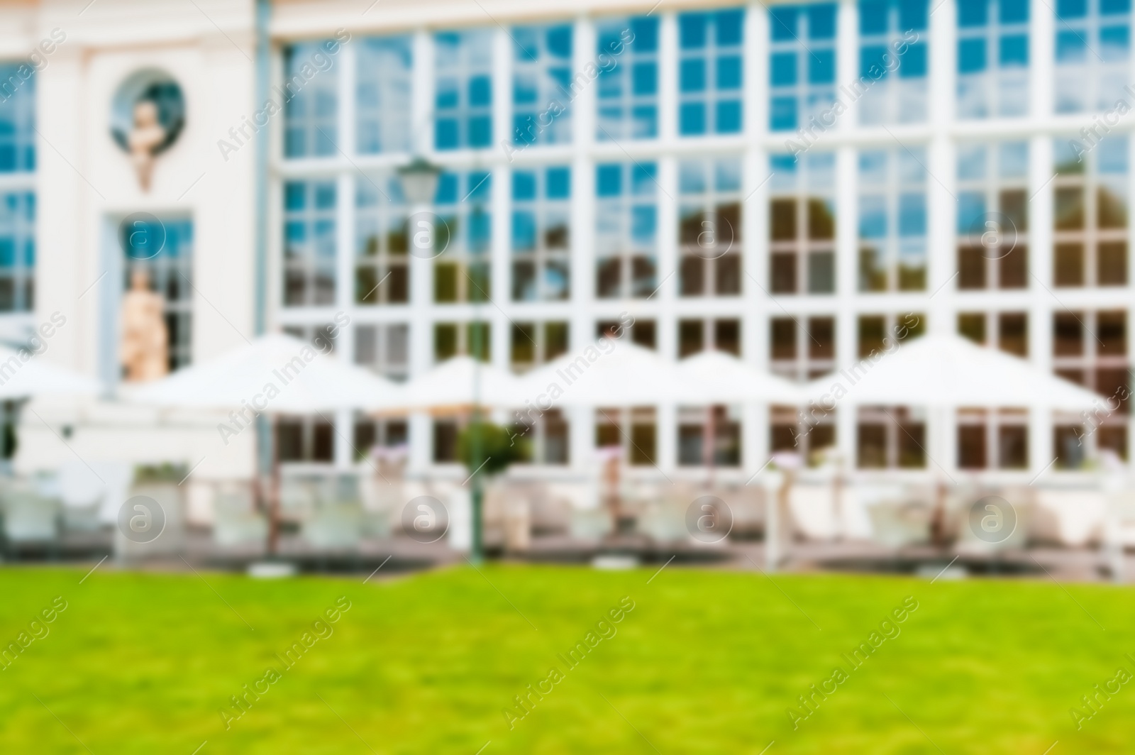 Photo of WARSAW, POLAND - MAY 15, 2022: Blurred view of cafe with outdoor terrace