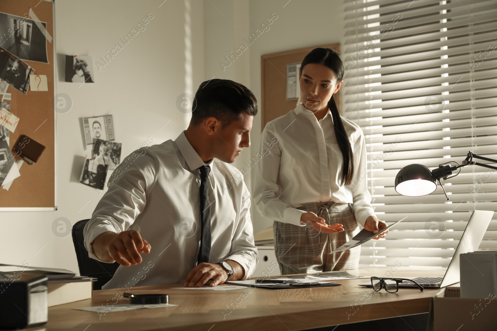 Photo of Professional detectives working at desk in office